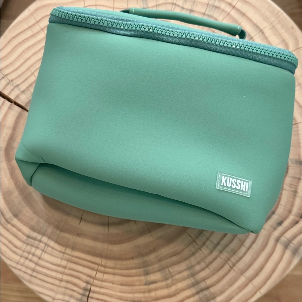 Mint Green Cosmetic Bag with Zippered Closure and Rounded Design KUSSHI train